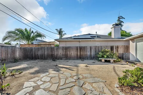 a view of a house with backyard and sitting area