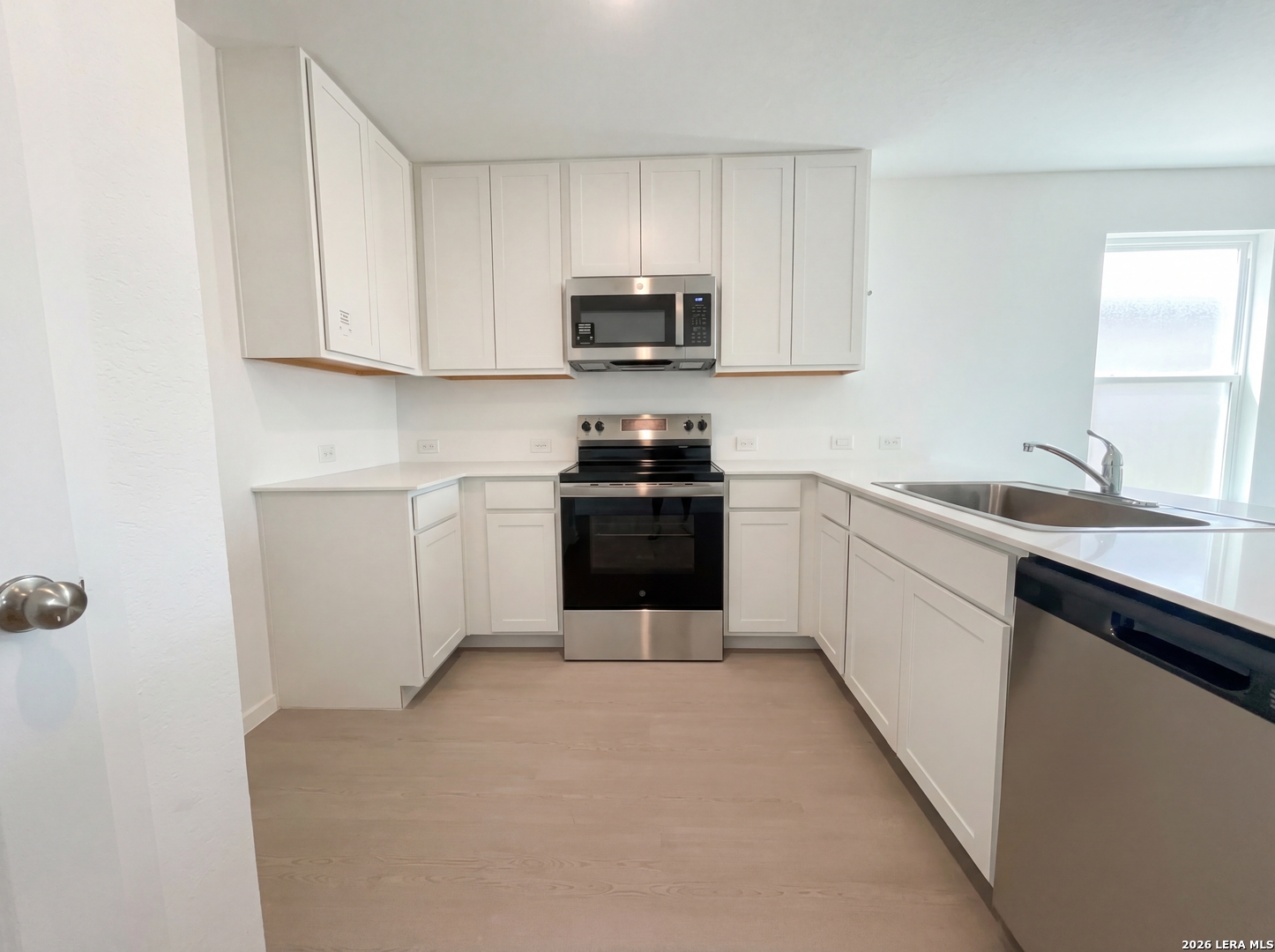 320 Pacific Waters Seguin, TX 78155 - Photo 2 of 16 a kitchen with a sink and white cabinets