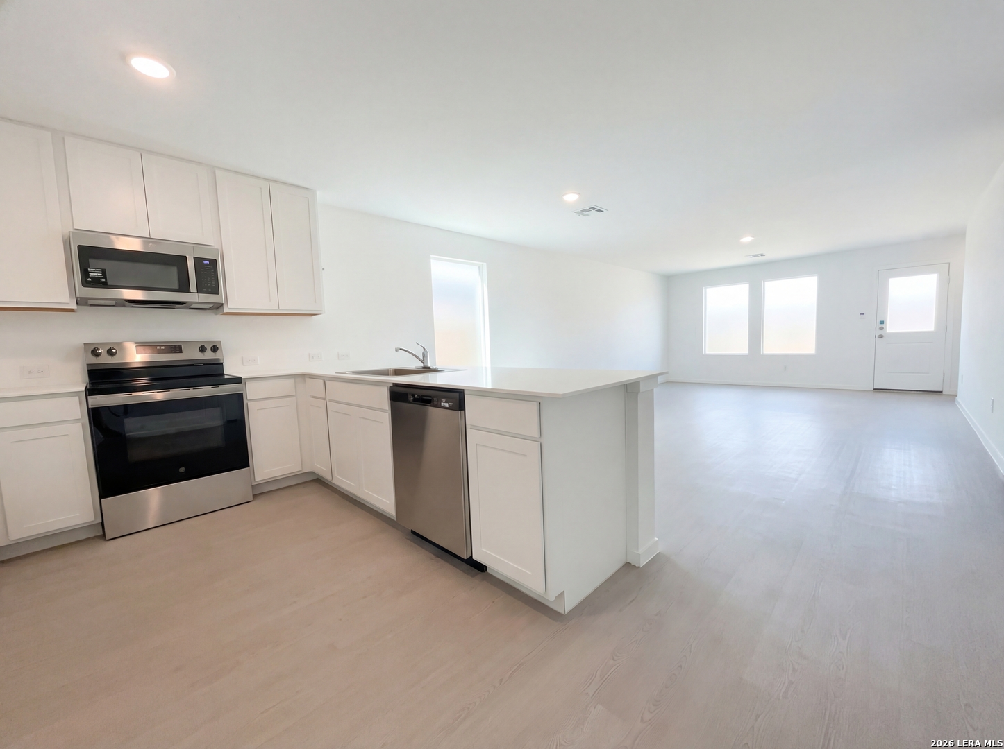 320 Pacific Waters Seguin, TX 78155 - Photo 7 of 16 a kitchen with stainless steel appliances granite countertop a stove a sink and a refrigerator
