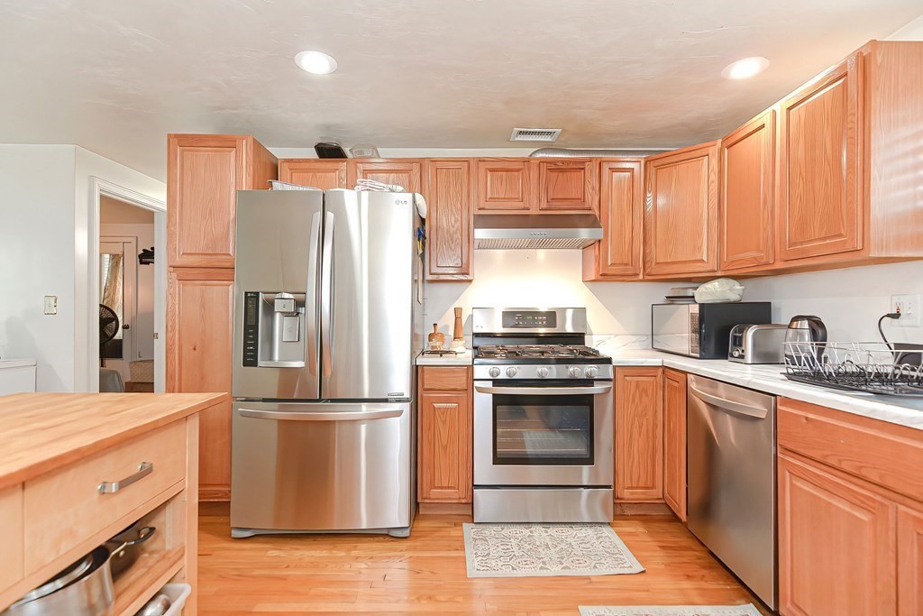 a kitchen with granite countertop stainless steel appliances a sink and counter space