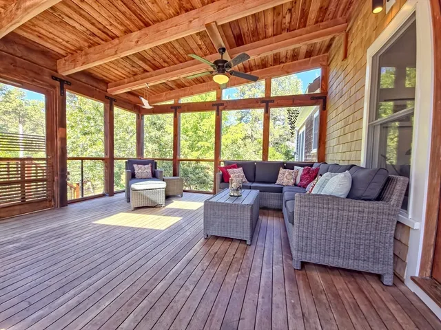 a view of a patio with table and chairs and wooden floor