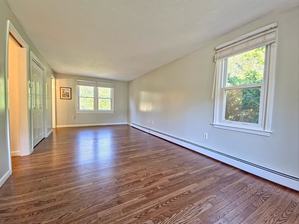 61 Wintergreen Road Mashpee, MA 02649 - Photo 14 of 35 a view of an empty room with wooden floor and a window