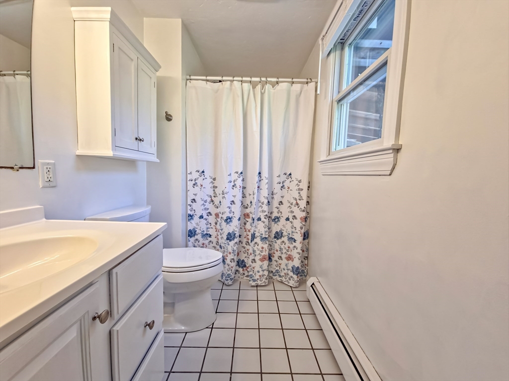 61 Wintergreen Road Mashpee, MA 02649 - Photo 16 of 35 a bathroom with a sink a toilet and shower curtain