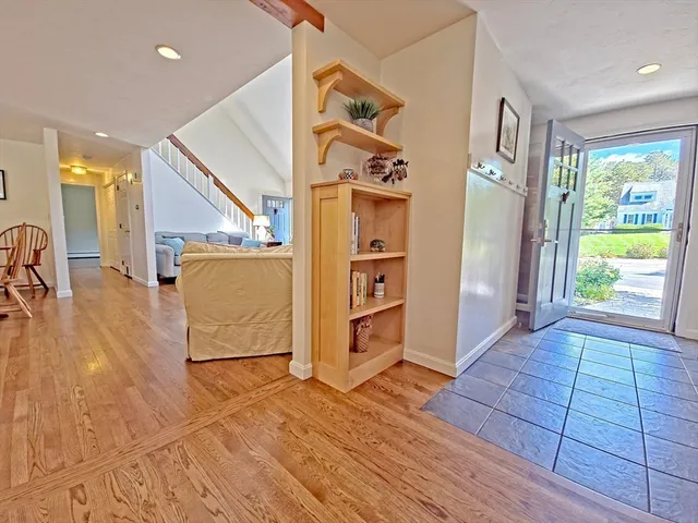 a view of a hallway with wooden floor and windows