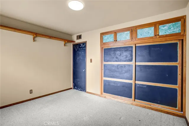 a view of empty room with window and ceiling fan