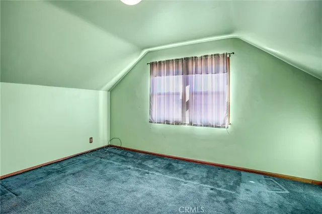 an empty room with windows and cabinet