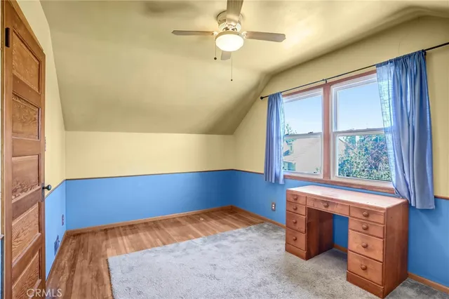 a view of a hallway with wooden walls