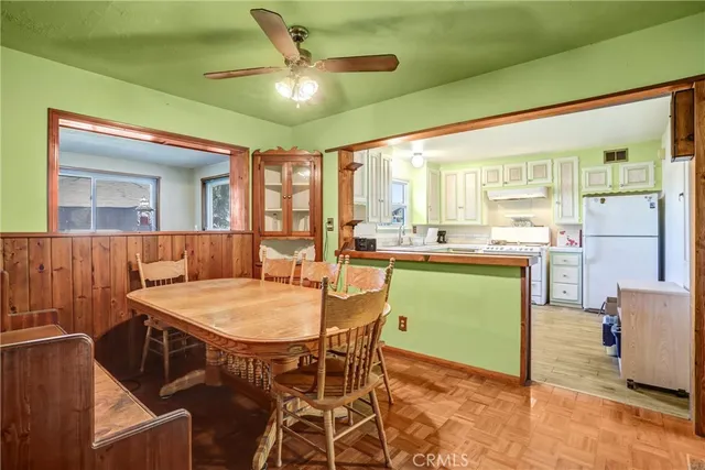 a kitchen with furniture and large windows