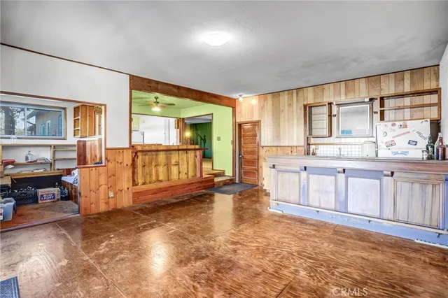 a view of a livingroom with furniture and an entryway