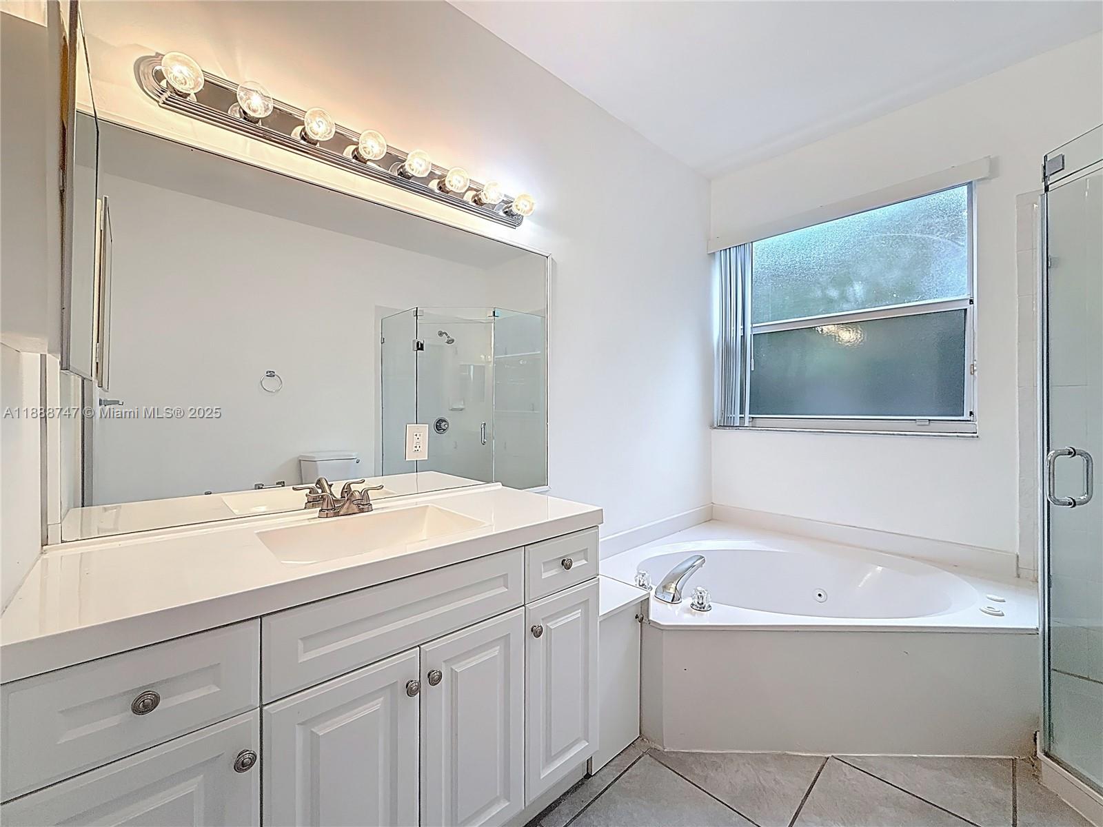 5317 Southwest 133rd Avenue Miramar, FL 33027 - Photo 21 of 38 a bathroom with a tub a sink and mirror