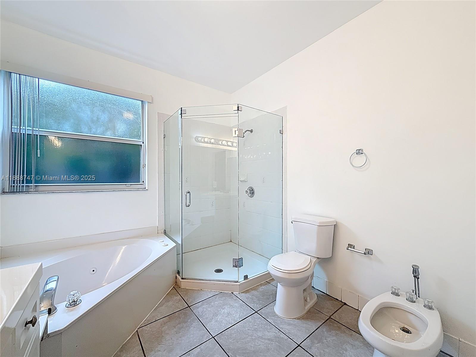 5317 Southwest 133rd Avenue Miramar, FL 33027 - Photo 22 of 38 a bathroom with a toilet a sink and bathtub