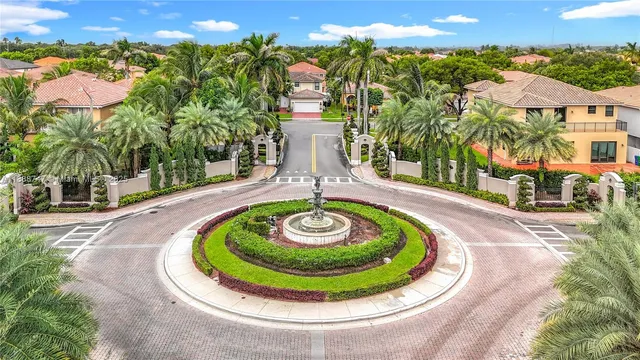 a view of a swimming pool with a yard and plants