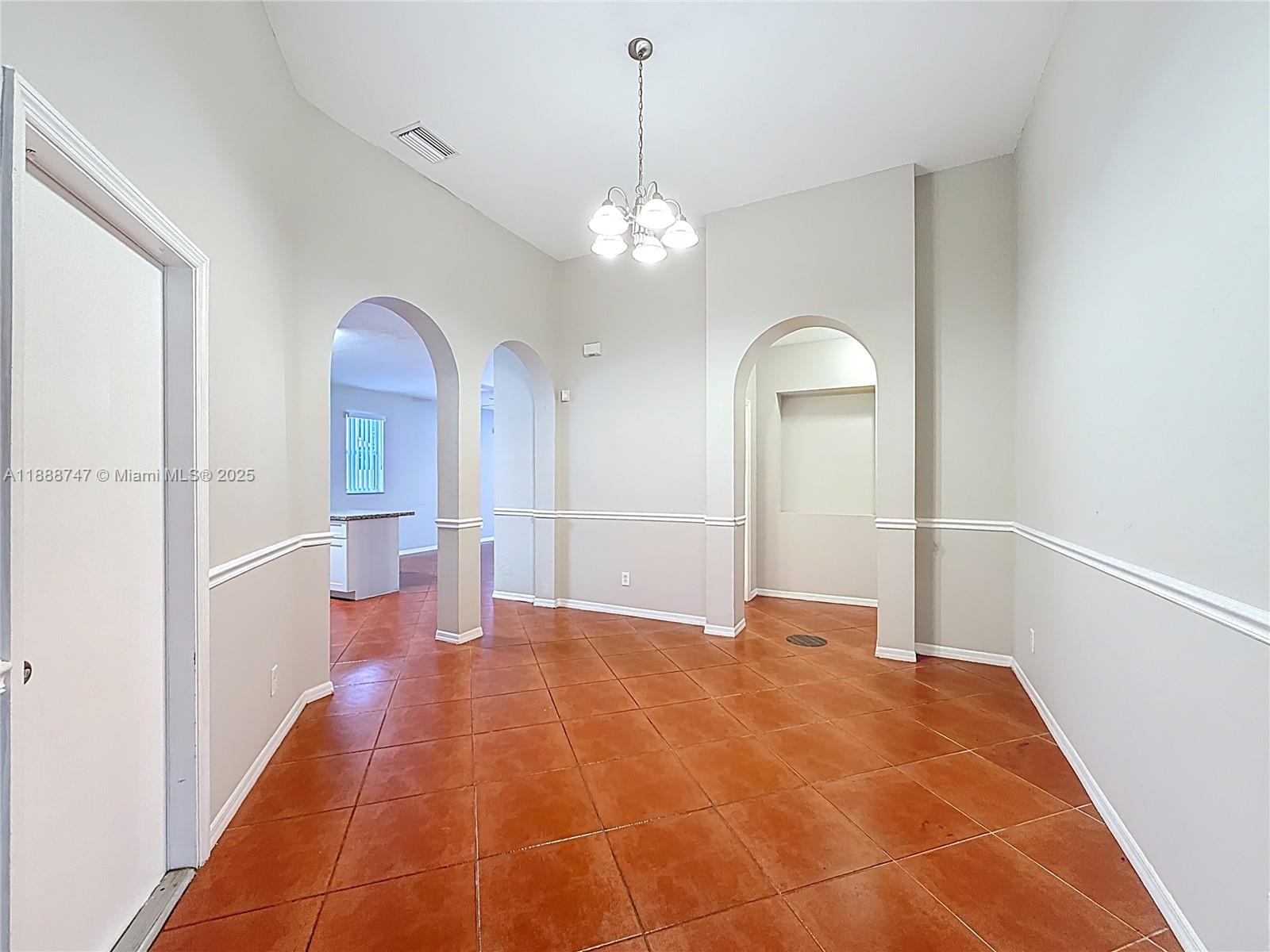 5317 Southwest 133rd Avenue Miramar, FL 33027 - Photo 7 of 38 a view of a room with a chandelier fan and wooden floor