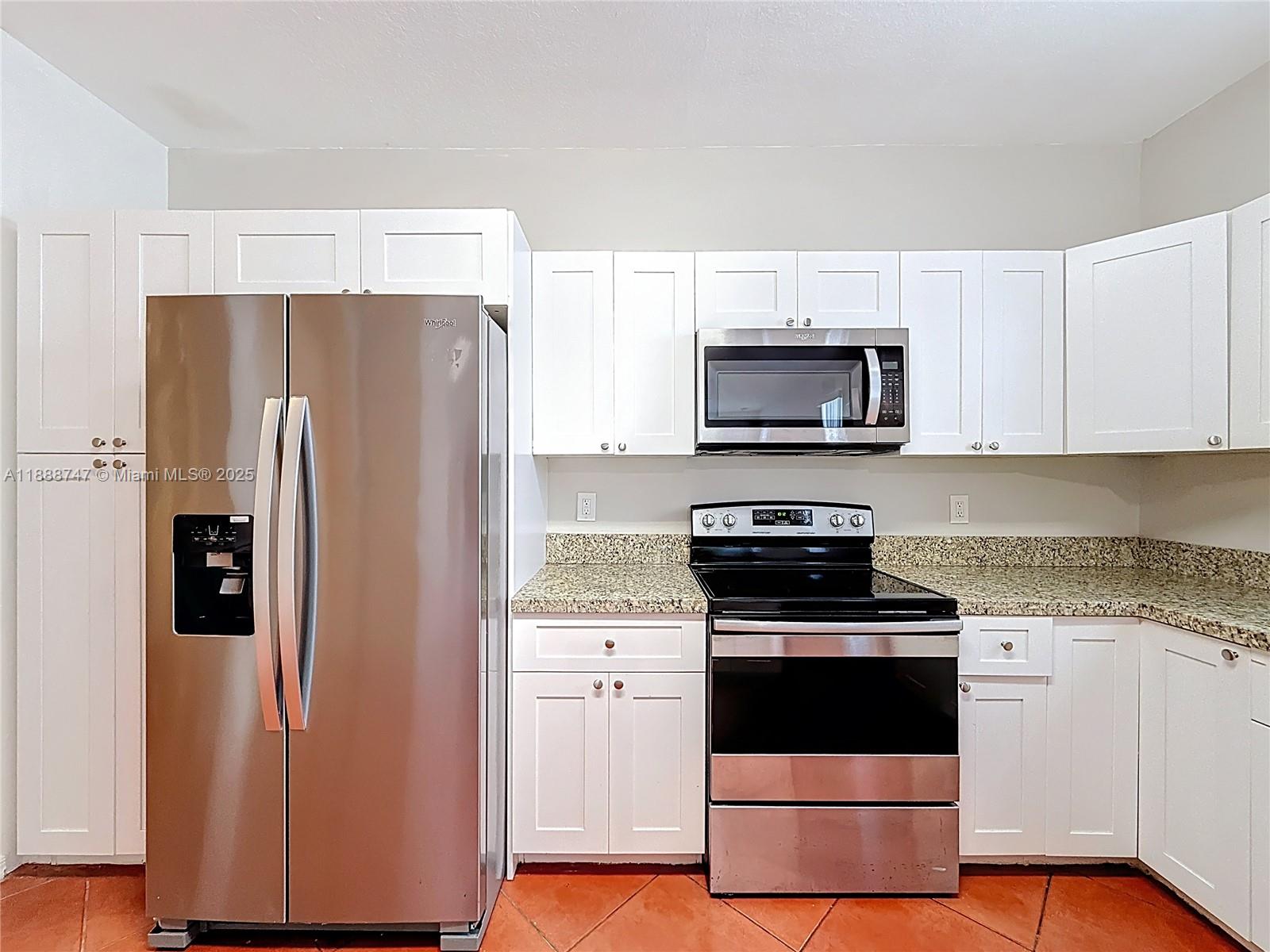 5317 Southwest 133rd Avenue Miramar, FL 33027 - Photo 9 of 38 a kitchen with stainless steel appliances a refrigerator stove and microwave