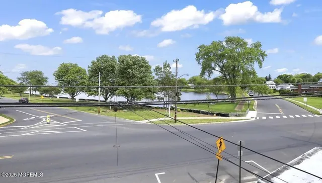 a view of swimming pool with outdoor seating and trees in the background