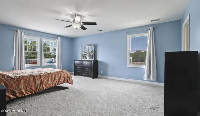 a bedroom with a bed dresser and a window