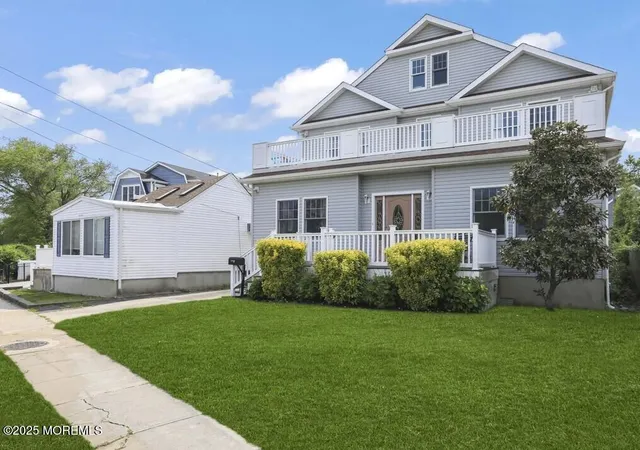 a front view of a house with a garden and yard