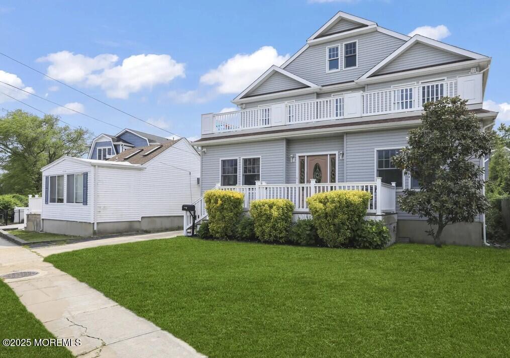 2207 Main Street Lake Como, NJ 07719 - Photo 2 of 22 a front view of a house with a garden and yard