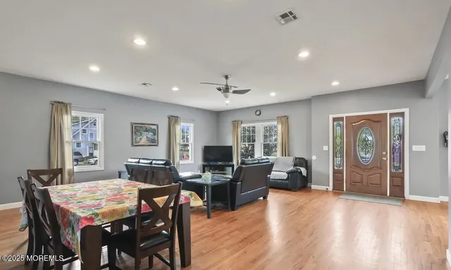 a view of a dining room with furniture window and wooden floor
