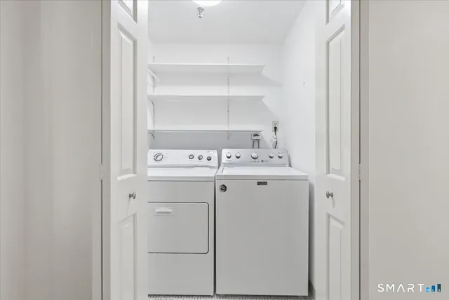 a utility room with cabinets washer and dryer