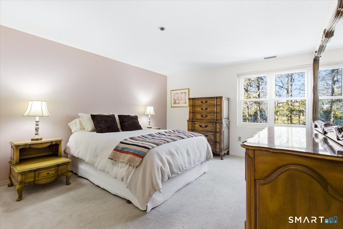 707 East Mix Avenue, Unit 38 Hamden, CT 06514 - Photo 14 of 26 a bedroom with a bed and a window