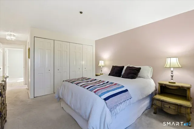 a bedroom with a bed and a lamp