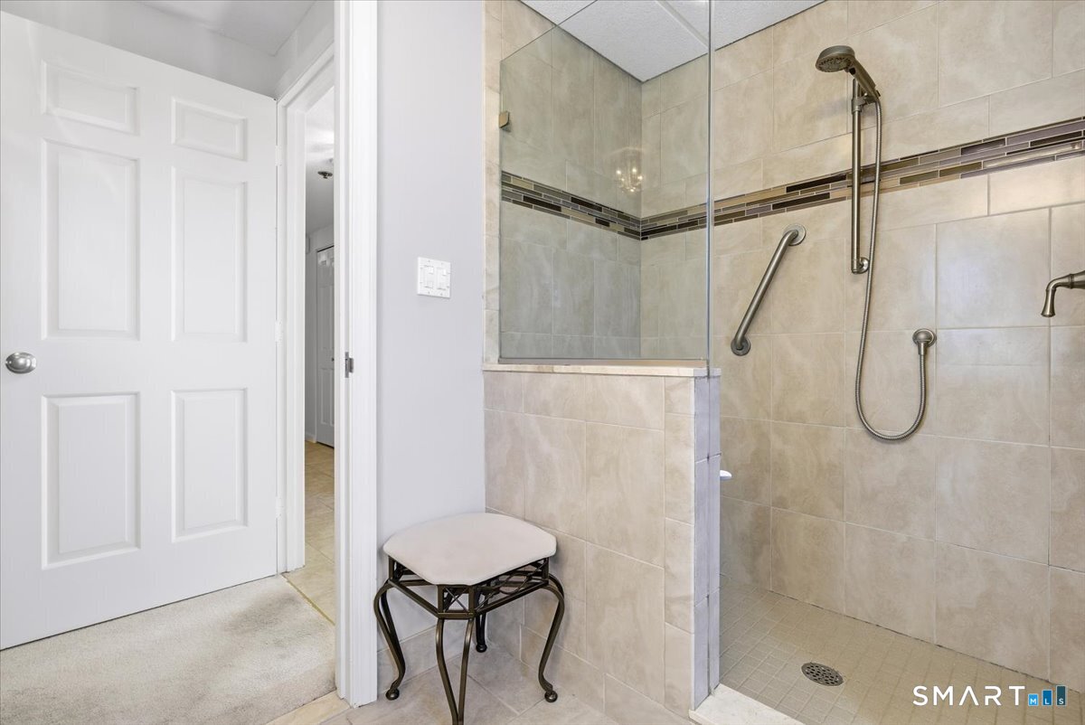 707 East Mix Avenue, Unit 38 Hamden, CT 06514 - Photo 17 of 26 a bathroom with a shower and a toilet