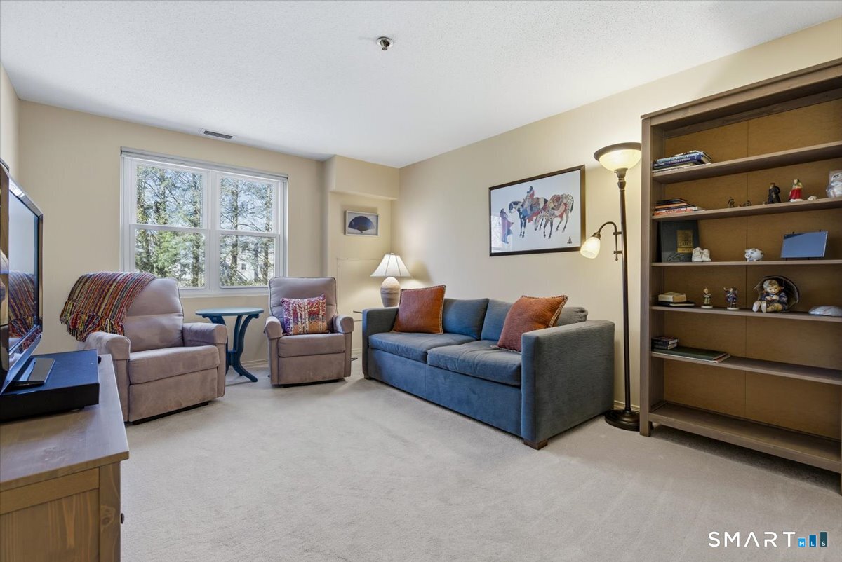 707 East Mix Avenue, Unit 38 Hamden, CT 06514 - Photo 18 of 26 a living room with furniture and a window