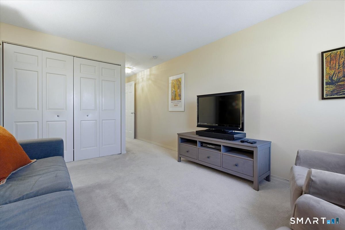 707 East Mix Avenue, Unit 38 Hamden, CT 06514 - Photo 19 of 26 a living room with furniture and a flat screen tv