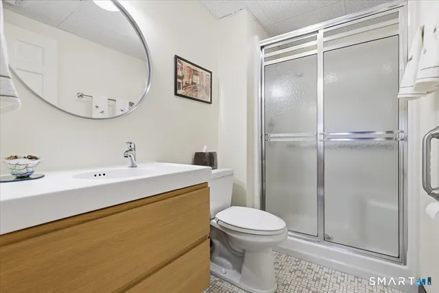 a bathroom with a sink mirror vanity and toilet