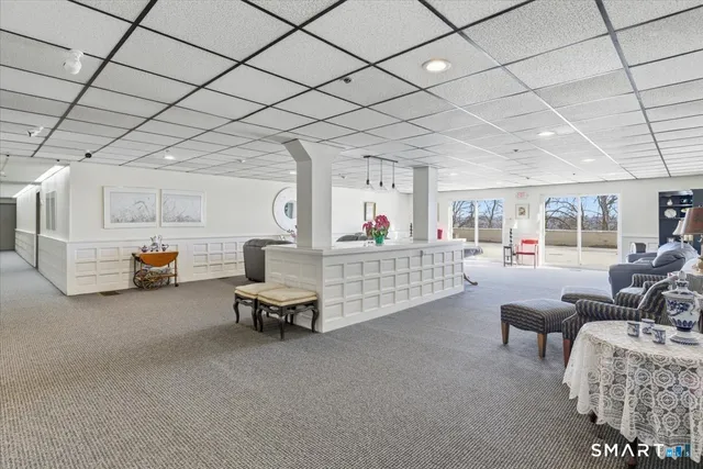 a living room with furniture and a gym machine