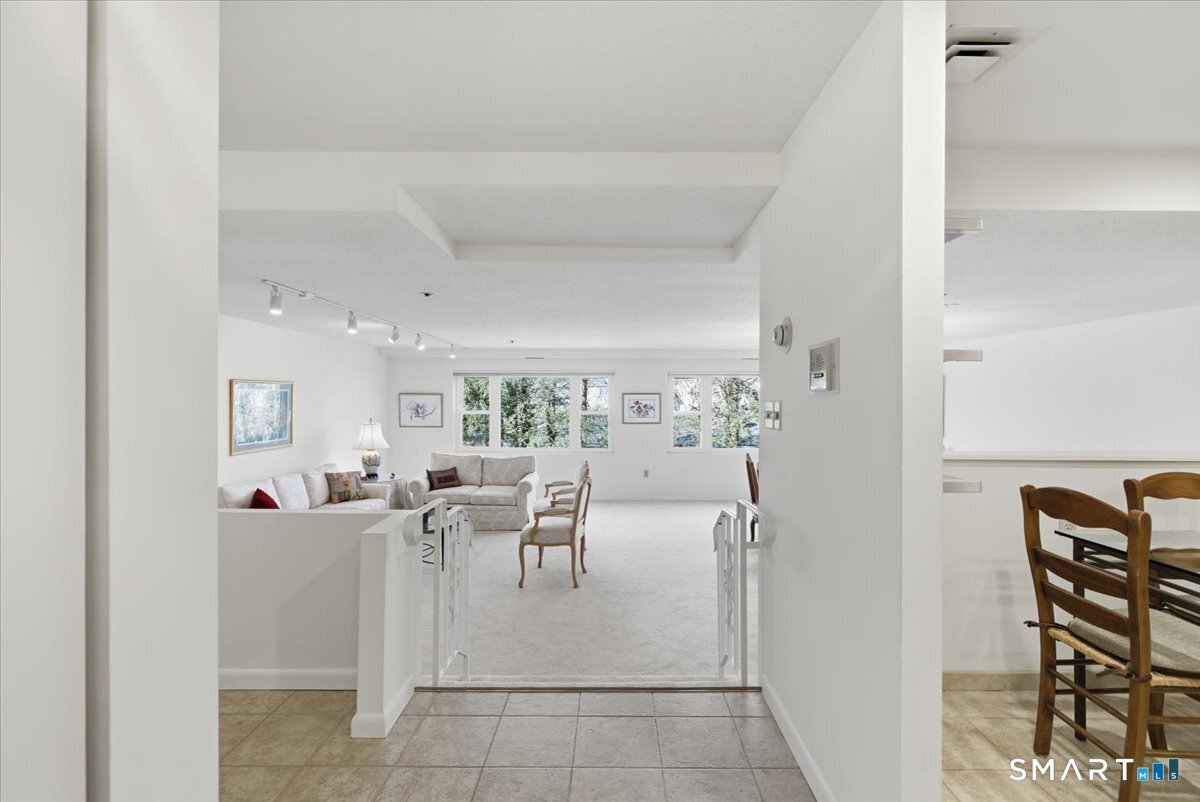 707 East Mix Avenue, Unit 38 Hamden, CT 06514 - Photo 3 of 26 a living room with furniture a rug and white walls