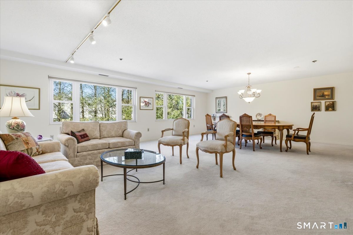 707 East Mix Avenue, Unit 38 Hamden, CT 06514 - Photo 4 of 26 a living room with furniture and a large window
