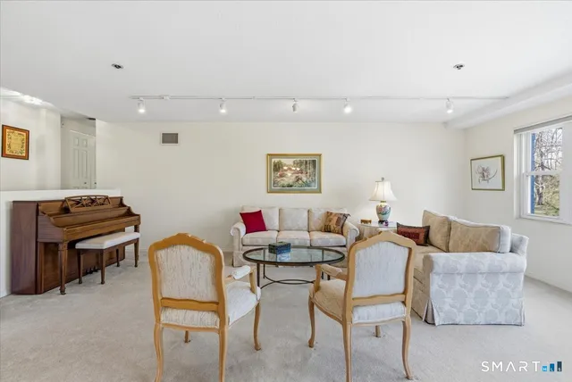 a living room with furniture and a piano