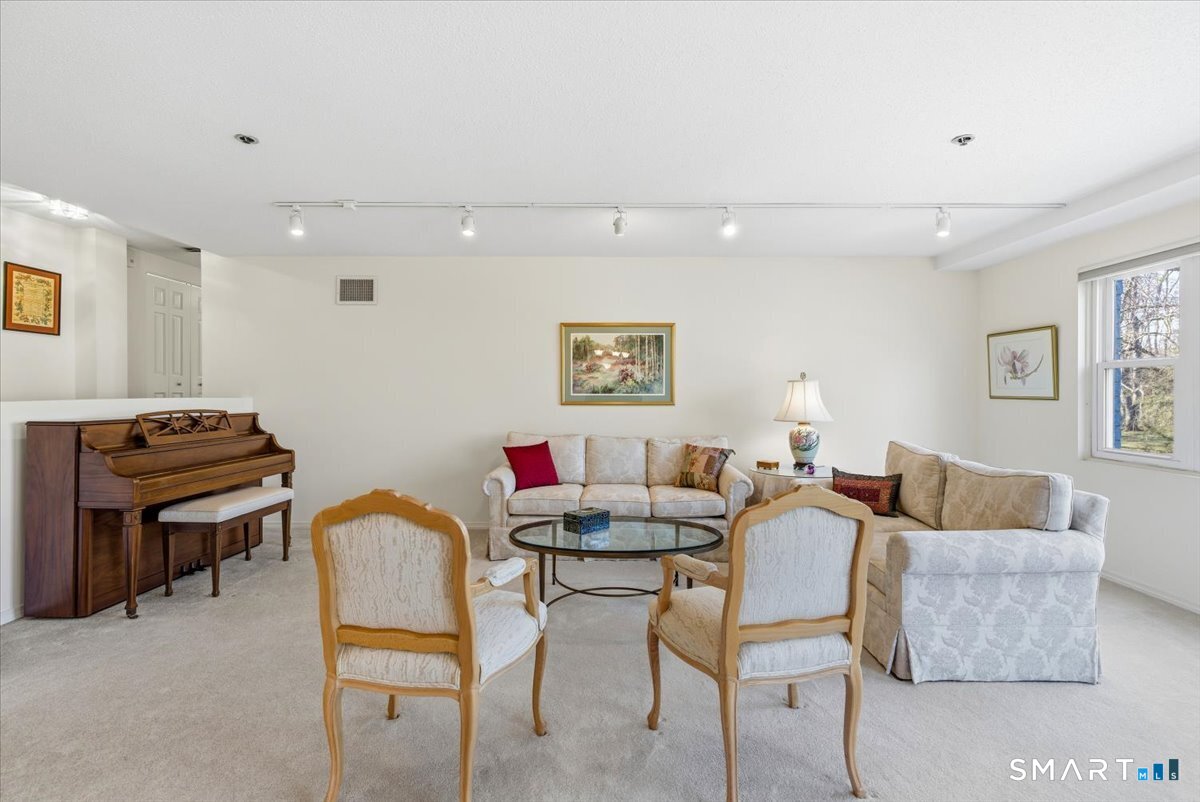 707 East Mix Avenue, Unit 38 Hamden, CT 06514 - Photo 5 of 26 a living room with furniture and a piano