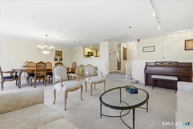 a living room with furniture a dining table and window