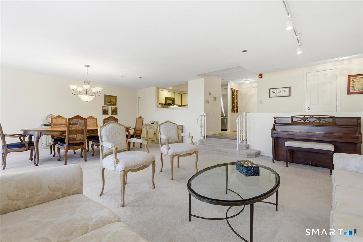 707 East Mix Avenue, Unit 38 Hamden, CT 06514 - Photo 6 of 26 a living room with furniture a dining table and window