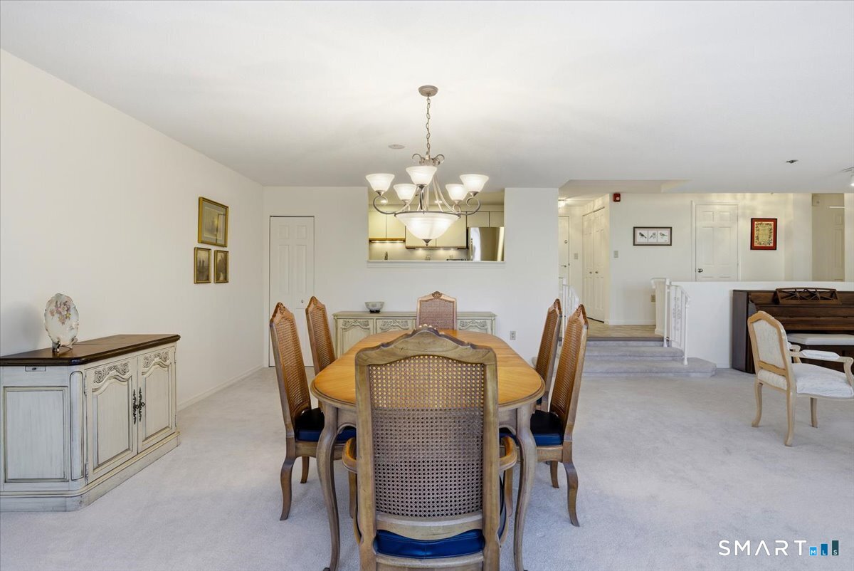 707 East Mix Avenue, Unit 38 Hamden, CT 06514 - Photo 9 of 26 a view of a dining room with furniture and chandelier