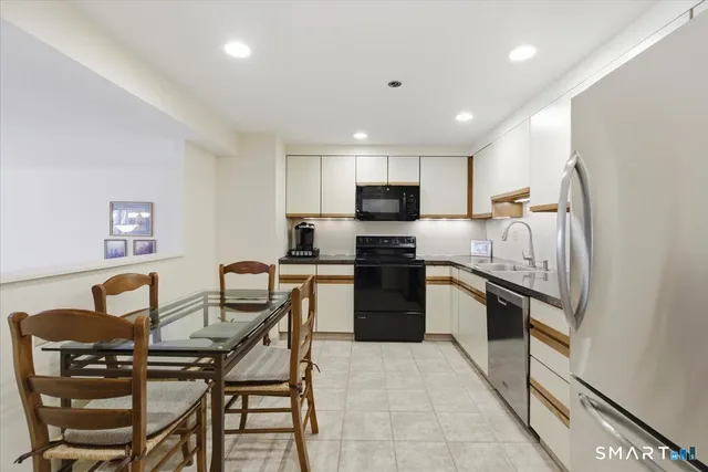 a kitchen with a refrigerator and a stove top oven