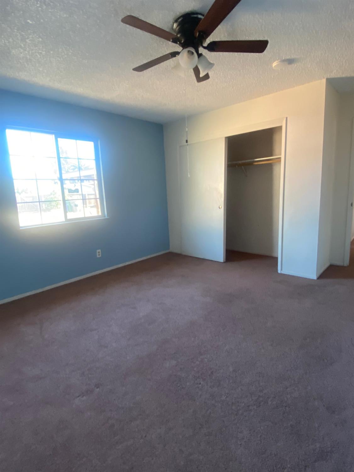 333 East Linden Avenue Reedley, CA 93654 - Photo 13 of 21 an empty room with windows and ceiling fan
