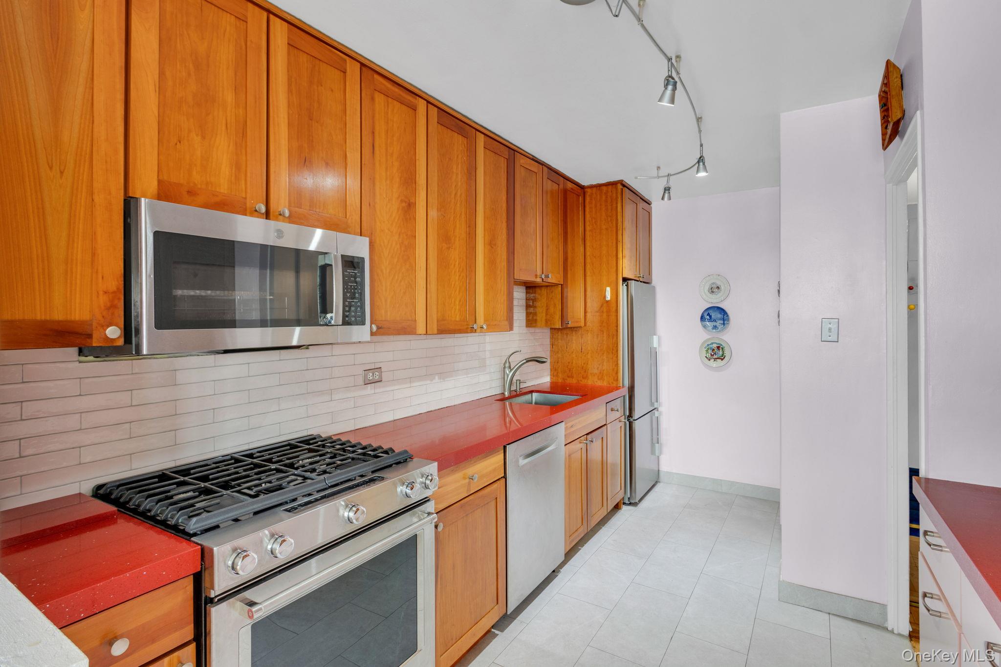 2500 Johnson Avenue, Unit 15P Bronx, NY 10463 - Photo 11 of 50 a kitchen with stainless steel appliances a stove a microwave and sink