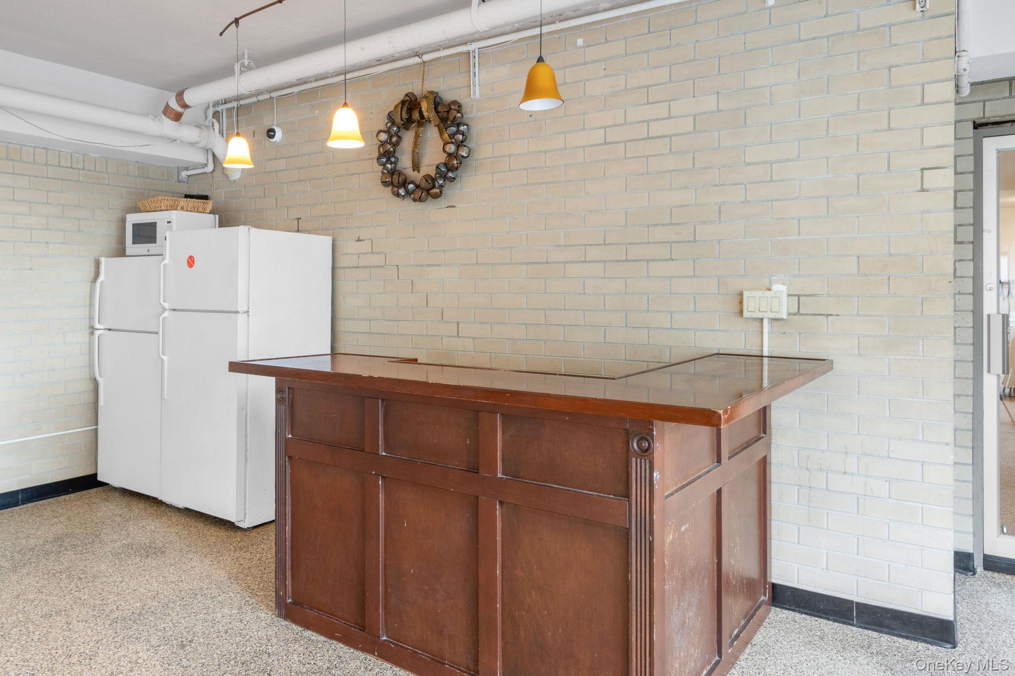 2500 Johnson Avenue, Unit 15P Bronx, NY 10463 - Photo 38 of 50 a utility room with a refrigerator and cabinets