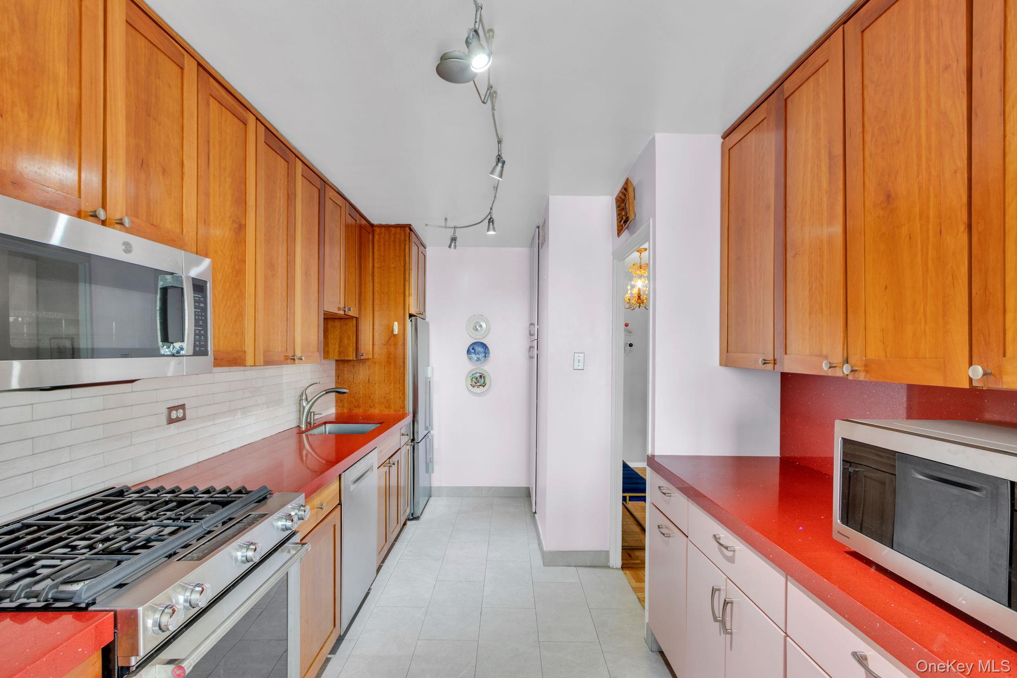 2500 Johnson Avenue, Unit 15P Bronx, NY 10463 - Photo 10 of 50 a kitchen with stainless steel appliances a stove a sink and a microwave