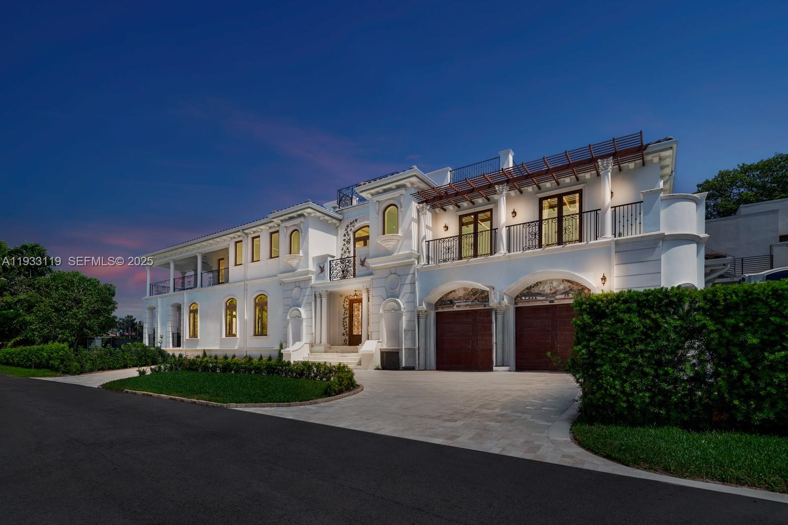 919 92nd Street Surfside, FL 33154 - Photo 13 of 40 a front view of a house with a garden and plants