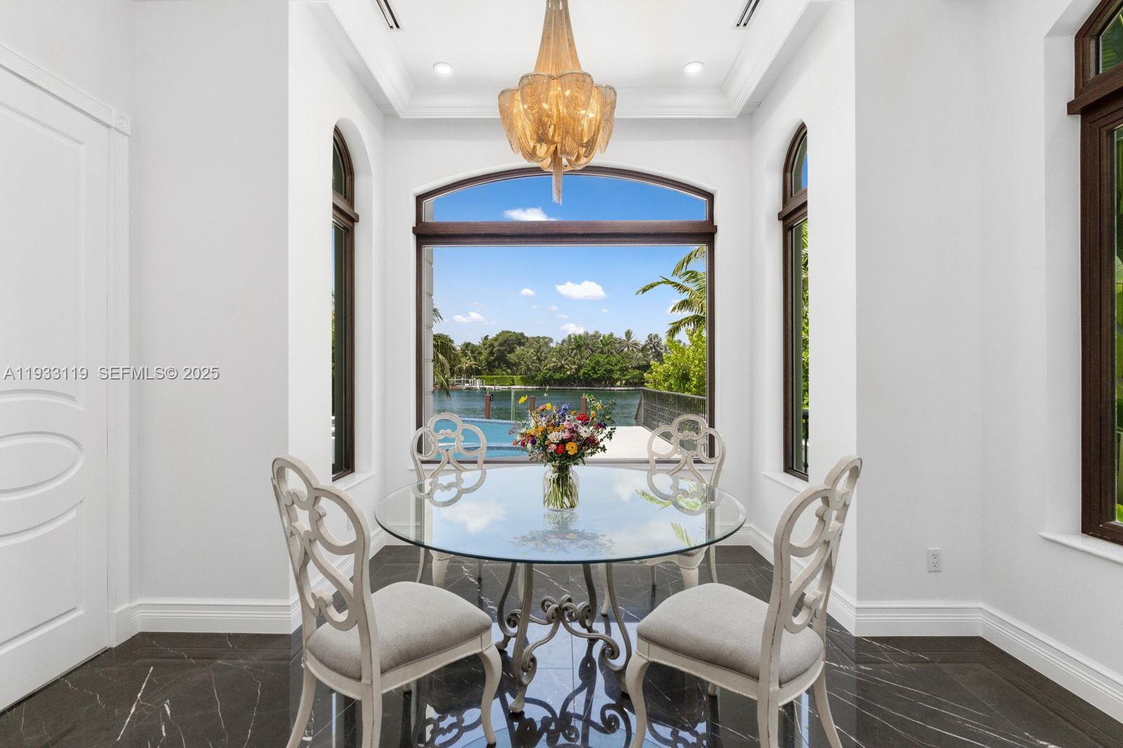 919 92nd Street Surfside, FL 33154 - Photo 21 of 40 a view of a dining room with furniture window and wooden floor