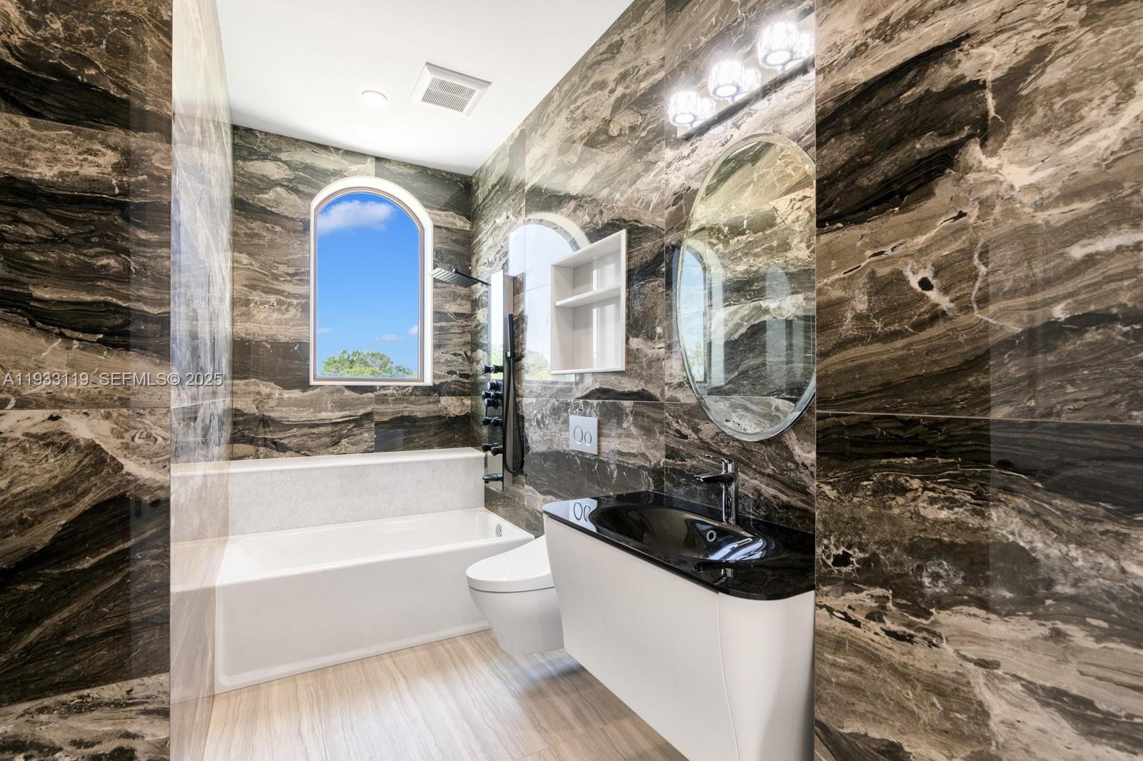 919 92nd Street Surfside, FL 33154 - Photo 32 of 40 a bathroom with a bathtub and a sink