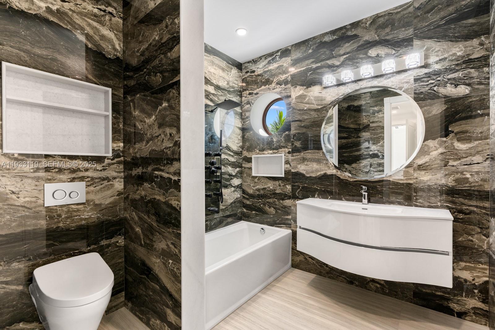 919 92nd Street Surfside, FL 33154 - Photo 34 of 40 a bathroom with a sink mirror vanity and toilet