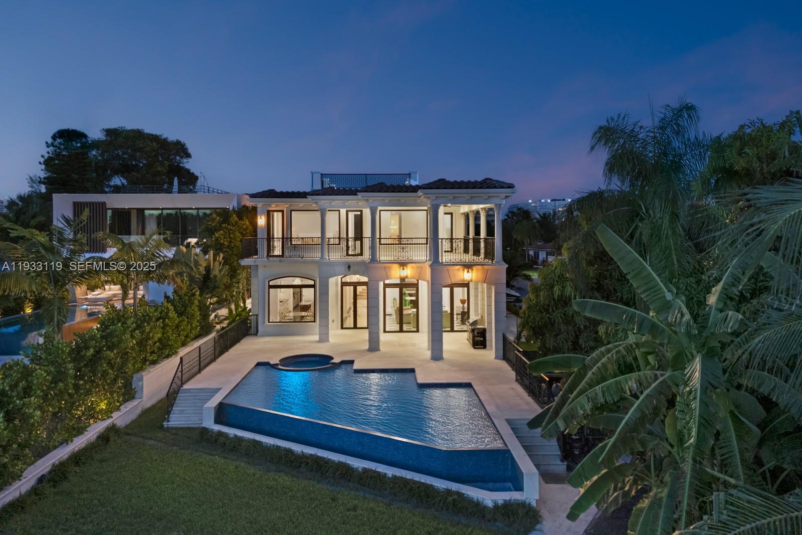 919 92nd Street Surfside, FL 33154 - Photo 4 of 40 a view of house with yard outdoor seating and green space