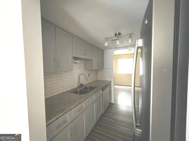 a kitchen with stainless steel appliances granite countertop a sink and a stove