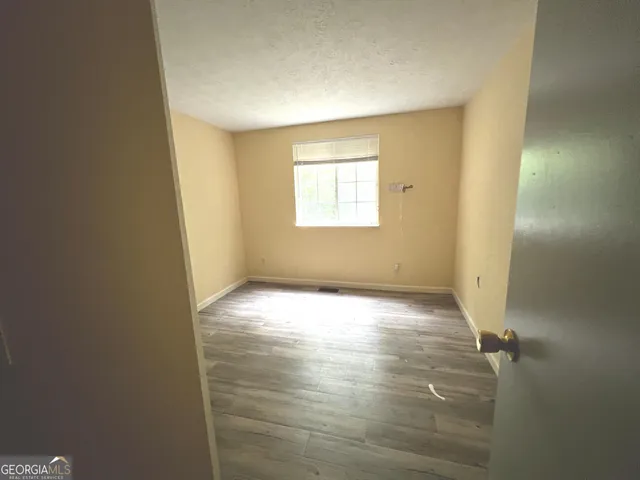 an empty room with a windows